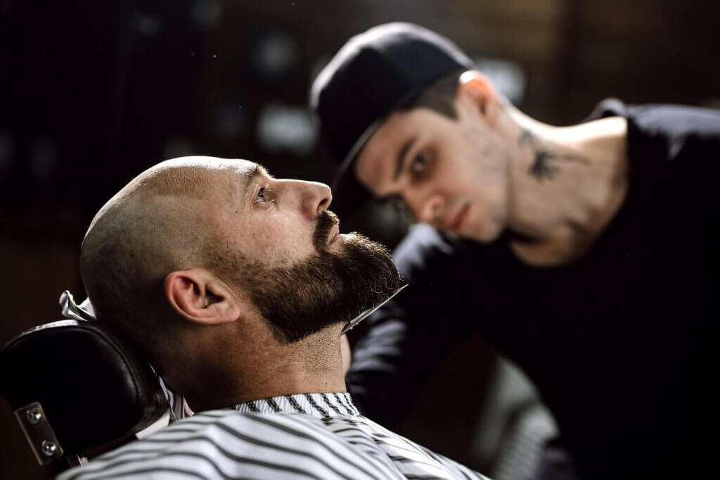 The Barber Dressed In A Black Clothes Scissors Beard Of Brutal Man In The Stylish Barbershop 1 Sculpt Your Perfect Look With Our Beard Trimming And Styling In Mississauga